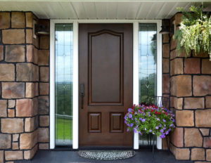 Entry door of house with stone clad siding